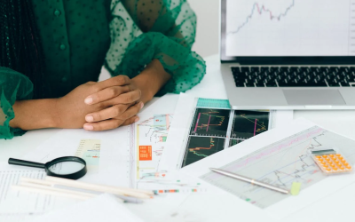 person analyzing documents with stock trends and risks