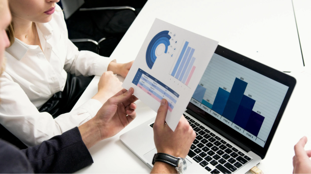 business professionals discussing data charts and graphs in a modern office setting