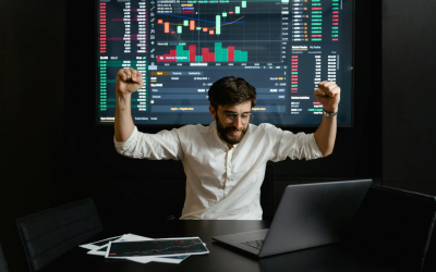 A successful businessman raising his hands triumphantly, symbolizing achievement and success