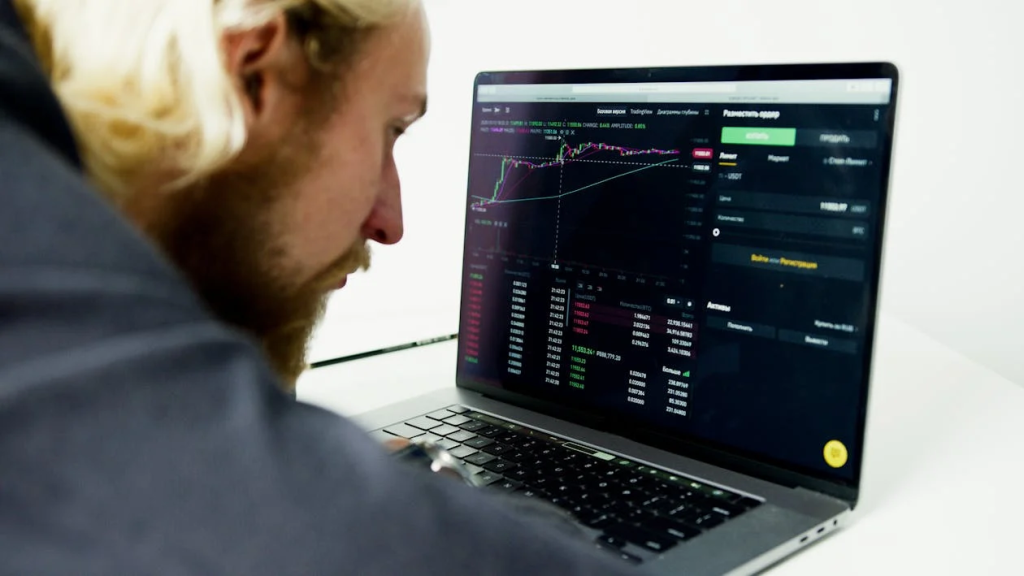 Man Looking at the Trading Data on the Computer Screen