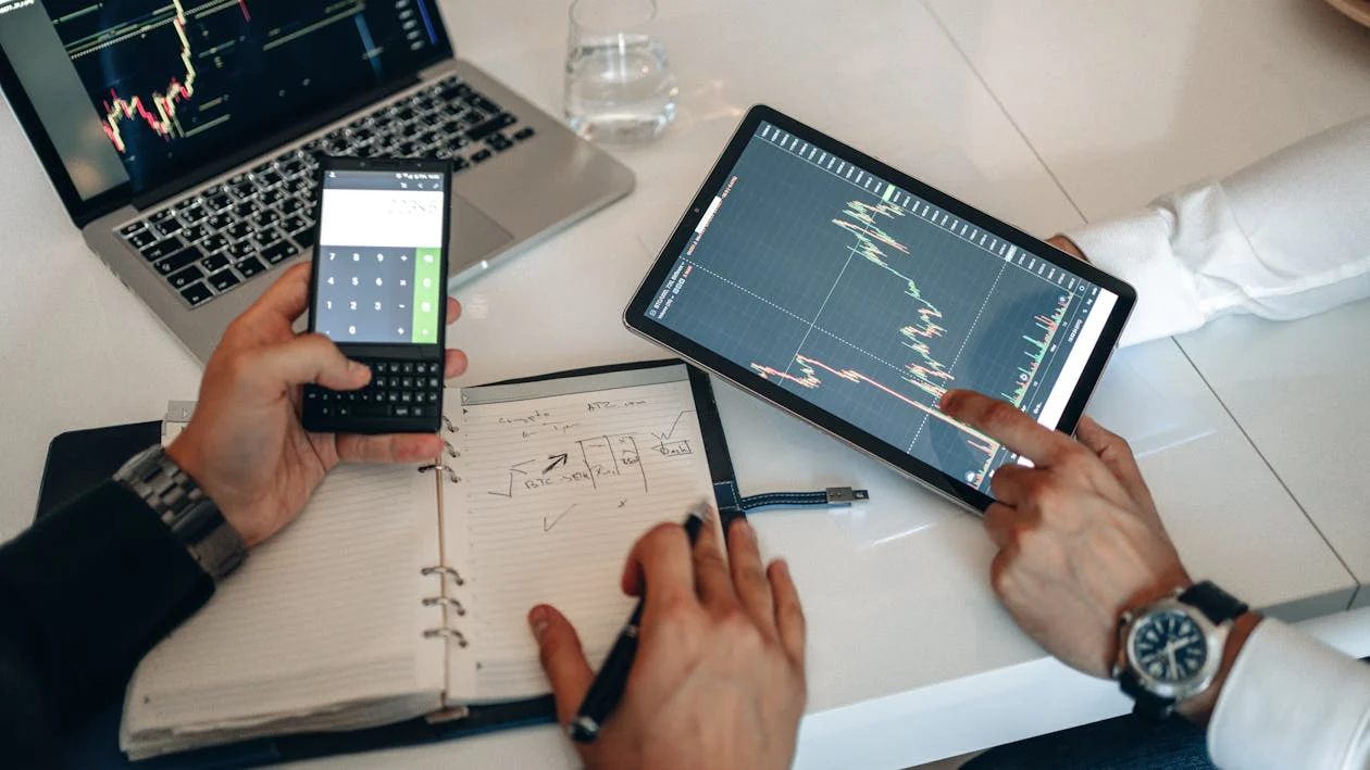 people analyzing stock data on a digital tablet 